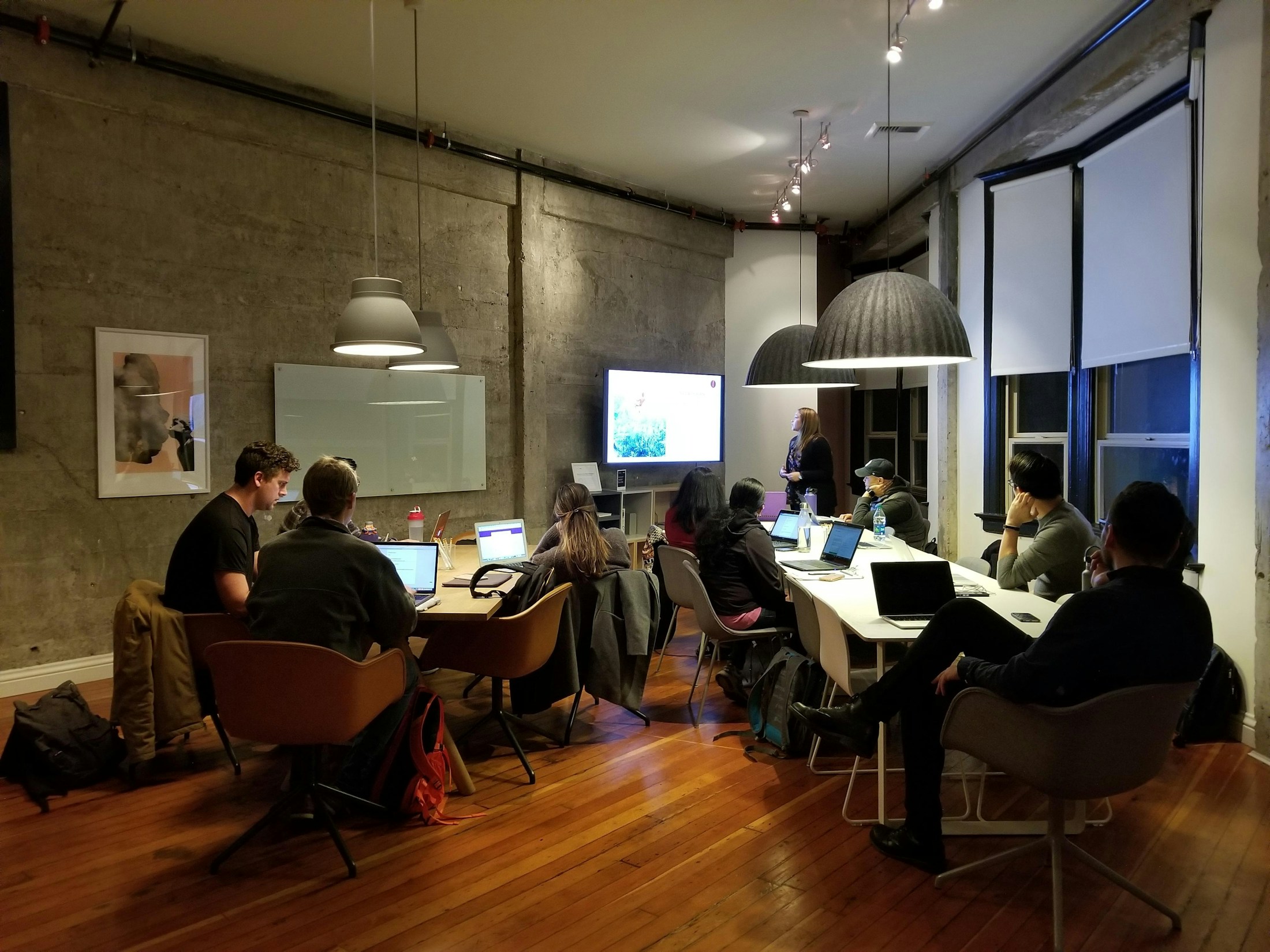 People collaborating around laptops at a shared table